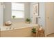 Clean bathroom features a soaking tub and a decorative window at 4264 Michaler St, North Port, FL 34286