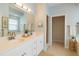 Bright bathroom with double sinks, a large mirror, and a separate shower area at 4264 Michaler St, North Port, FL 34286