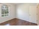 Bedroom with wood floors, neutral paint, a window and a white door at 4264 Michaler St, North Port, FL 34286