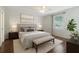 Comfortable bedroom with a queen bed, a ceiling fan, and a large window at 4264 Michaler St, North Port, FL 34286