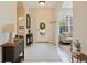 Inviting home foyer with an oval glass front door and neutral-colored flooring and accents at 4264 Michaler St, North Port, FL 34286
