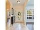 Welcoming foyer with tiled flooring, arched doorways, a decorative mirror, and views of the living spaces at 4264 Michaler St, North Port, FL 34286