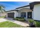 Charming home featuring a well-maintained lawn, inviting entryway, and a two-car garage at 4264 Michaler St, North Port, FL 34286