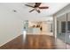 Open-concept living room with hardwood floors, a ceiling fan, and sliding glass doors to the patio at 4264 Michaler St, North Port, FL 34286
