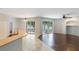 Open living area with tile and wood flooring leading to screened in patio at 4264 Michaler St, North Port, FL 34286