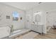 Modern bathroom featuring white marble walls, patterned tile, glass shower and vanity with storage at 4513 21St N St, St Petersburg, FL 33714