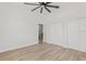 Spacious bedroom featuring wood-look flooring, closet, ceiling fan, and access to an adjoining room at 4513 21St N St, St Petersburg, FL 33714