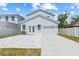 Exterior view of home with white fence, concrete driveway and attached one car garage at 4513 21St N St, St Petersburg, FL 33714