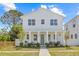 Charming two-story home with light blue exterior, inviting front porch, and well-manicured lawn at 4513 21St N St, St Petersburg, FL 33714