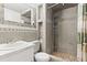 Tiled bathroom features a vanity and shower, providing a clean and functional space at 4521 Tidal Pond Rd, New Port Richey, FL 34652