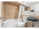 Bathroom featuring vanity, toilet, shower over tub and decorative tiling at 4521 Tidal Pond Rd, New Port Richey, FL 34652