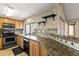 Well-equipped kitchen featuring stainless steel appliances, granite countertops, and a decorative tile backsplash at 4521 Tidal Pond Rd, New Port Richey, FL 34652