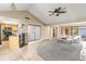 Spacious living room flows into the kitchen with vaulted ceilings, neutral paint at 4521 Tidal Pond Rd, New Port Richey, FL 34652