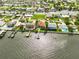 An aerial view highlighting the waterfront home with a dock, pool, and proximity to the water at 4823 Arlington Rd, Palmetto, FL 34221