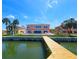 View of a waterfront backyard featuring a private dock and a patio area for relaxing and enjoying waterfront outdoor living at 4823 Arlington Rd, Palmetto, FL 34221