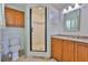 Cozy bathroom features a shower stall, toilet, mirror and wood cabinets at 4823 Arlington Rd, Palmetto, FL 34221