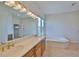 Bathroom featuring dual sinks, a vanity, and a large soaking tub at 4823 Arlington Rd, Palmetto, FL 34221