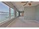 Bright bedroom featuring large windows with a waterfront view and neutral color scheme at 4823 Arlington Rd, Palmetto, FL 34221