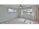 Light-filled bedroom with neutral carpet, ceiling fan, and picturesque windows at 4823 Arlington Rd, Palmetto, FL 34221