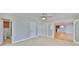 Spacious bedroom with ceiling fan, tile flooring, view to a bathroom, and doorways at 4823 Arlington Rd, Palmetto, FL 34221