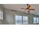 Serene bedroom with ceiling fan and picturesque windows showcasing water views at 4823 Arlington Rd, Palmetto, FL 34221