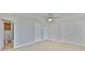 Bedroom with ceiling fan, tile flooring, view to a bathroom, and doorways at 4823 Arlington Rd, Palmetto, FL 34221