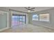 Bedroom features a ceiling fan, a sliding glass door and tile flooring at 4823 Arlington Rd, Palmetto, FL 34221
