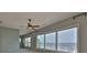 Bedroom showcasing a ceiling fan and expansive windows with water views at 4823 Arlington Rd, Palmetto, FL 34221