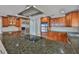 Granite countertop island with cooktop, stainless appliances, and custom wood cabinets at 4823 Arlington Rd, Palmetto, FL 34221