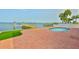 Inviting pool deck featuring a private dock and easy access to the water with palm trees at 4823 Arlington Rd, Palmetto, FL 34221