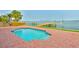 Inviting pool deck featuring a private dock and easy access to the water with palm trees at 4823 Arlington Rd, Palmetto, FL 34221