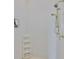 Modern shower with white tile, brass fixtures, and convenient shelving at 4823 Arlington Rd, Palmetto, FL 34221