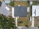 Aerial view of the home showcasing the dark roof, lawn, and landscaping at 5685 35Th N Ave, St Petersburg, FL 33710