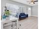 Bright living room featuring neutral walls, a comfortable sofa, and a well-lit workspace at 5685 35Th N Ave, St Petersburg, FL 33710