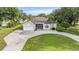 Aerial view of home with large driveway and manicured front lawn at 6411 Barton Rd, Plant City, FL 33565