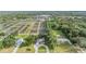Stunning aerial view of a well-maintained property with lush landscaping, mature trees, and outbuildings at 6411 Barton Rd, Plant City, FL 33565