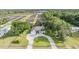 Inviting aerial view of a residence on a large lot with mature trees and a circular driveway at 6411 Barton Rd, Plant City, FL 33565