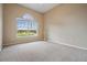 Carpeted bedroom featuring a large window providing ample natural light at 6411 Barton Rd, Plant City, FL 33565