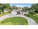 Aerial view of charming home with a well-manicured lawn and circular driveway at 6411 Barton Rd, Plant City, FL 33565
