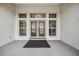 Elegant double front doors with decorative ironwork and transom windows, creating a grand entrance at 6411 Barton Rd, Plant City, FL 33565