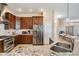 Modern kitchen featuring granite countertops, stainless steel appliances, and dark wood cabinetry at 6411 Barton Rd, Plant City, FL 33565