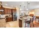 Stylish kitchen with stainless appliances, granite counters, bar seating, and hardwood flooring at 6411 Barton Rd, Plant City, FL 33565