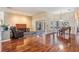 Spacious living room with hardwood floors, piano, and sliding glass doors to the outdoor space at 6411 Barton Rd, Plant City, FL 33565