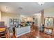 Bright living room with hardwood floors, a piano, and a view of the outdoor pool area at 6411 Barton Rd, Plant City, FL 33565