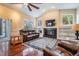 Comfortable living room with hardwood floors, a fireplace, and access to outdoor spaces at 6411 Barton Rd, Plant City, FL 33565