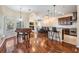 Open-concept living space with hardwood floors, fireplace, and a seamless flow to the kitchen at 6411 Barton Rd, Plant City, FL 33565