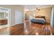 Large main bedroom with wood floors, a ceiling fan, and an en suite bathroom at 6411 Barton Rd, Plant City, FL 33565