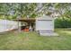 Backyard shed with a lean-to and adjacent white fence at 6411 Barton Rd, Plant City, FL 33565