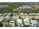 This aerial view highlights a neighborhood with a mix of single-Gathering homes and multi-story buildings at 6551 S West Shore Cir, Tampa, FL 33616