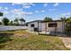 Wide shot of the backyard with an open patio area and white vinyl fence at 6551 S West Shore Cir, Tampa, FL 33616